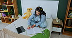 Student, headphones and laptop with writing on bed for online education, elearning and listening to lesson. Home, girl and study in book with technology for university, audio and knowledge of lecture