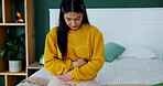 Woman, stomachache and massage on bed, cramps and appendicitis in home for discomfort. Female person, digestion and constipation or ulcer in bedroom, muscle strain and bloating or menstrual crisis