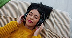 Top view, music and girl in bed for relaxing, resting and comfortable while sleeping in home. Face, radio and podcast with headphones by person in bedroom, daydreaming and chilling with playlist 