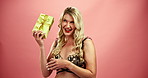 Happy woman, box and laughing with gift in lingerie for pleasure or curious on a red studio background. Portrait of female person, model or young blonde with ribbon present, fun prize or anniversary