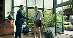 Man, greeting and handshake for welcome to hotel on travel business, assistance and luggage or suitcase for courtesy or professionalism. People, shaking hands and escort hospitality service for guest