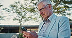 Mature, businessman and smartphone typing outdoor for thinking, notification or communication on internet. Male person, chat or reading communication on tech for networking, online or social media