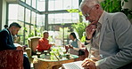 Laptop, thinking and business people in coworking space of coffee shop for planning or remote work. Computer, corporate and management with mature CEO in cafe for problem solving or research online