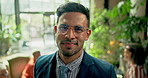 Confident, professional and face of business man in cafeteria with pride, career and smile. Creative workspace, plants and portrait of worker with glasses in office for meeting, planning and teamwork