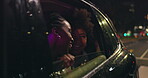 Women, friends and window of car in night for city view, travel and outdoor street excitement for new urban life. Girls, driving and downtown with wind in hair for car ride sightseeing and tour.