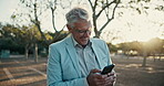 Mature, businessman and smartphone texting in street with smile, thinking or communication on internet. Male person, happy and reading communication on tech for networking, online or social media