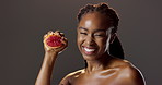 Grapefruit, skincare and portrait of black woman in studio for natural beauty, glow and cosmetics. Dermatology, fruit detox and happy girl with confidence, makeup or healthy skin on dark background