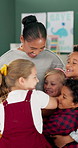 Happy woman, teacher and hug with young students for childhood development, learning or education at school. Female person or educator with smile for embrace, children or love in elementary classroom