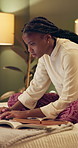 University, bed and black woman on laptop at night for online research, studying and learning. Education, academy and female student on computer for knowledge, typing project and website in bedroom