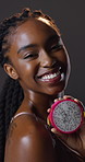 Skincare, face or black woman in studio with dragon fruit wellness, cosmetics or treatment on dark background. Smile, portrait or gen z girl with pitaya seed for gut health, detox or beauty balance