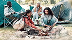 Camping, friends and fire wood in nature for heat by tent on adventure, holiday or vacation in forest. Diversity, travel and women with sticks for campfire, backpacking or winter getaway in woods