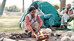 Camping, woman and fire with wood in nature for heat by tent on adventure, holiday or vacation in forest. Campsite, travel and person with friends for campfire, backpacking or winter getaway