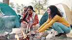 Women, camping and fire in nature for casual with friends, freedom or conversation in countryside. Group, people and forest with wood for flame in winter, adventure or holiday with communication