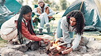 Camping, women and bonfire with wood in nature for heat by tent on adventure, holiday or vacation in forest. Campsite, travel and friends with sticks for campfire, backpacking or winter getaway