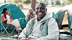 Man, face and happy in nature for camping, smile and holiday or getaway with friends. Vacation, adventure and camper chair, park and outdoor or eco friendly travel in forest for spring break