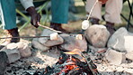 Friends, marshmallows and camping fire in nature, group and holiday treat or vacation with wood. Bonfire, adventure and bonding together or eating outdoor, relax and campsite for warm in park