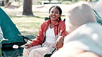 Woman, friends and camper in nature taking, laughing and holiday or getaway with for peace. Roasting treat, vacation or adventure and camping in park, outdoor and relax in chair on spring break 