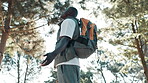 Hiking, black man and freedom in forest for breath, relaxing and fresh air on vacation outdoor with calm. Adventure, journey or holiday in nature for wellness, peace and male camper in countryside