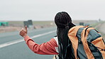 Black woman, hike and thumbs up on highway for road trip journey or adventure, tour with hitchhiking to see countryside. Girl, hand gesture for car stop for transportation and commute on vacation.