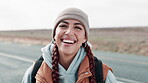 Highway, hiking and portrait of woman in countryside for journey, safety or immigration. Smile, travel and person with backpack for freedom, flee conflict or waiting for lift on road in America