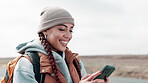 Backpack, smile and woman with phone by road for travel, communication and update on location. Countryside, happy and female person with technology for adventure, navigation and media notification