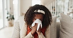 Sick, little girl and blowing nose with tissue on sofa for fever, flu or symptoms in living room at home. Young female person, child or kid with cold, illness or allegies on lounge couch at house