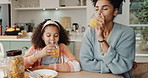 Mother, child and morning breakfast in home, cereal and nutrition meal with orange juice for vitamins and energy. Girl, happy and drinking in kitchen counter together, healthy and childcare bonding