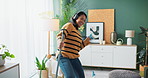 Woman, headphones and cleaning with dancing in home with music, radio and housework fun with broom. Cleaner, person and energy with audio streaming for hygiene, dust and housekeeping in living room