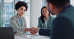 Business people, handshake and recruiting with documents for partnership, b2b or deal together at office. Young employees shaking hands with paperwork for hiring, meeting or discussion at workplace