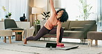 Online yoga class, tablet and woman on floor of living room in home for fitness, health or wellness. Exercise, stretching and technology with yogi person in apartment for holistic training or zen