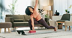 Online yoga class, tablet and woman on floor of home living room for fitness, health or wellness. Exercise, stretching and technology with serious person in apartment for holistic training or zen