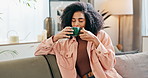 Black woman, relax and smelling coffee with aroma for caffeine, hot beverage or latte on sofa at home. Calm African or young female person enjoying morning drink, cappuccino or warm scent at house