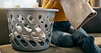 Basket, hands and laundry with person on sofa in living room of home closeup for cleaning. Clothing, folding and housekeeping in lounge of apartment for chores, hygiene or washing fabric and textile