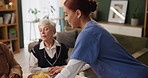 Elderly women, caregiver and food for support group in home with health, therapy and wellness. Senior people, therapist and community in house for healthcare, empathy and counseling with snacks