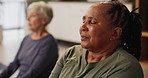 Senior woman, group and yoga class with eyes closed, peace or meditation for reflection in retirement. Elderly African person, mindfulness and zen perspective with people for wellness in nursing home