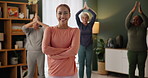 Woman, arms crossed and smile at senior yoga class for namaste, peace or exercise for health. Personal trainer, elderly people and group for mindfulness, diversity or zen in portrait at nursing home