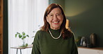 Face, retirement and smile with elderly woman laughing in living room of home to relax for weekend time off. Emotion, funny and portrait of happy elderly senior person in apartment for wellness