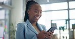 Business, typing and black woman on smartphone in office for social media, networking or internet post. Online, laughing and employee at packaging agency for conversation, texting or communication