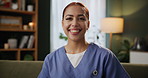 Smile, nurse and face of woman on sofa for healthcare, medical support or trust in living room. Wellness, portrait and caregiver in scrubs for confidence, happiness or volunteer work in nursing home