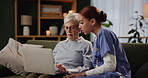Senior woman, caregiver and laptop in home for help, support and care on sofa in living room. Elderly person, nurse and confused on couch in house for advice with internet, website and technology