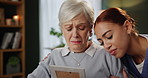 Senior, woman and caregiver with photo for support with grief, memory and mourning in home with hugging lost love. Elderly, person or nurse with picture frame in retirement for remember or compassion