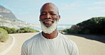 Mature, athlete and running on road with headphones for fitness, workout or marathon training music. Black man, smile and exercise podcast in mountain jog for cardio wellness, health or sport radio