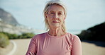 Mature, athlete and running on road with face for fitness, workout or marathon training. Senior woman, arms crossed and exercise in mountain jog for cardio wellness, health or sport for retirement