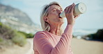 Senior woman, drinking water and outdoor for exercise, road and break for fitness, training or health in park. Person, bottle and hydration on street for detox, workout or thinking with smile on path