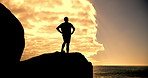 Person, silhouette and fitness with ocean view on rock with sunset sky, training and exercise for wellness. Runner, achievement and outdoor on cliff for workout, summer or running in nature by sea