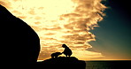 Person, silhouette and play with dog by ocean view on rock with sunset sky, training and exercise for wellness. Runner, care and pet animal on cliff for workout, summer and clouds in nature by sea