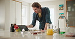 Cooking, tablet and man at kitchen counter with online recipe for instructions, meal prep or nutrition, Food, read and gen z person with technology for ingredients, steps and search internet in home