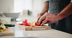 Hands, knife and cutting with home, kitchen and cooking for food or nutrition for diet. Person, vegetables and red peppers for lunch, dinner or meal with chopping board and ingredients or preparation