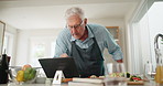 Cooking, tablet and senior man at kitchen counter with online recipe for instructions, meal prep or nutrition, Food, read and elderly person for ingredients, steps and search internet in home