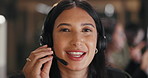 Happy woman, call center and consultant with headphones for customer service or support at office. Face of female person, employee or agent talking on mic for communication, CRM or telemarketing